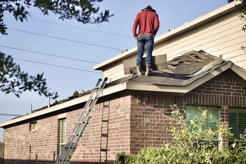 Professional roofer working on a residential roof in Lake Como
